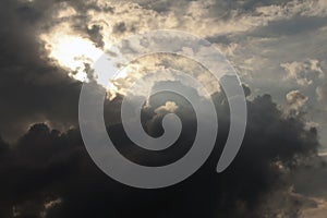 Dramatic sun beams through dark clouds