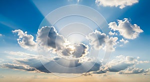 Dramatic sun rays bursting through blue sky clouds