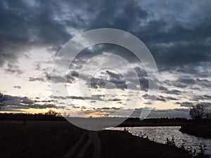 Dramatic sun set night sky countryside side of river