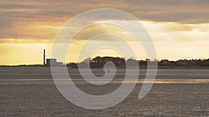 Dramatic sun shafts or sun rays emerge from the clouds, New England coastline