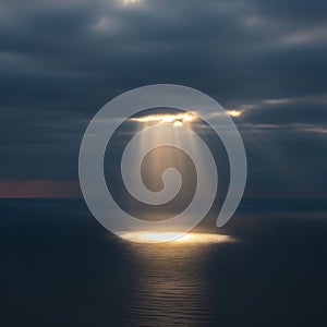 Dramatic Sunbeam on Dark Ocean Surface