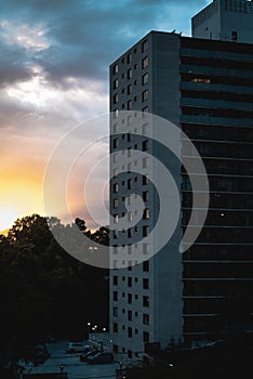 Dramatic sunbeams behind the Residential Building With Reflections in a Windows, Background Photo