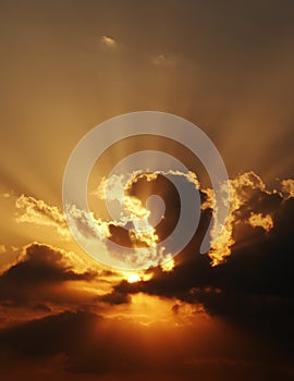 Dramatic sundown scene with dark clouds and rays