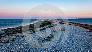 dramatic sunrise over the baltic sea with rocky beach and trees