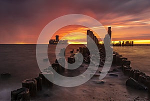 Dramatic sunrise over the sea. Famous place on the Baltic coast, beach near the old torpedo plant