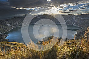 Dramatic sunrise shot of the volcanic caldera and Quilotoa lake and crater