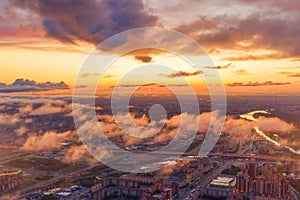 Dramatic sunrise sky with low clouds over the urban panoramic landscape view