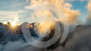 Dramatic sunset above clouds within high alpine peaks, Saas-Fee, Switzerland, Europe