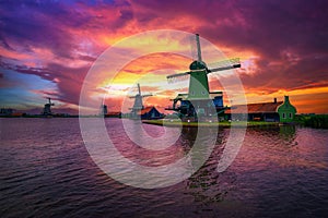 Dramatic sunset above farm houses and windmills of Zaanse Schans, Netherlands