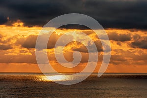 Dramatic sunset at Black Sea. Beautiful seascape of sun rays, scenic sky and clouds