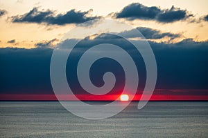 Dramatic sunset at Black Sea. Beautiful seascape of sun and scenic sky and clouds