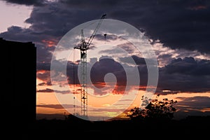 Dramatic Sunset in the Cityscape with Crane