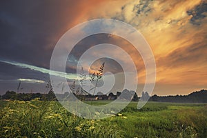 Dramatic Sunset Clouds over Green Countryside Fields