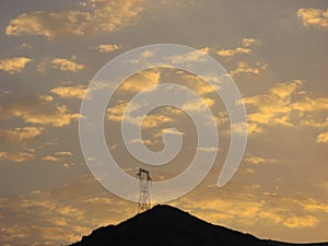 Dramatic sunset cloudy sky with clouds lit by sunset sunlight.