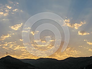 Dramatic sunset cloudy sky with clouds lit by sunset sunlight.