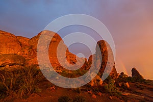 Dramatic sunset colors, clouds and rain in Arches National Park desert