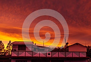 Dramatic sunset colours in the sky above a house