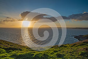 Dramatic sunset on Cornish coast , over Atlantic Ocean
