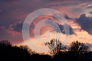 Dramatic sunset with dark clouds and glimpses of light.