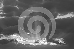 Dramatic sunset with dark clouds and glimpses of light.