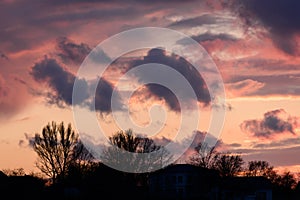 Dramatic sunset with dark clouds and glimpses of light.