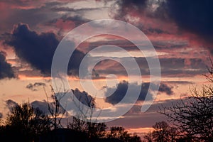 Dramatic sunset with dark clouds and glimpses of light.
