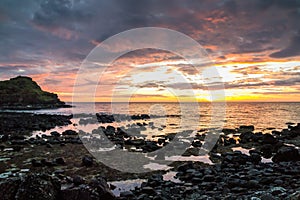 Dramatic sunset on the Giant`s Causeway coast, Northern Ireland