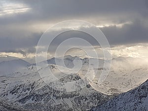 Dramatic sunset in the mountain. Cloudy sky at sunset. High mountain snowy landscape