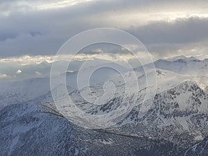 Dramatic sunset in the mountain. Cloudy sky at sunset. High mountain snowy landscape