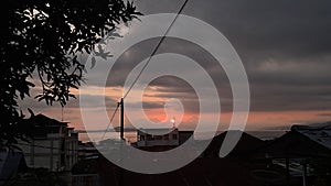 Dramatic sunset over the bay and city rooftops