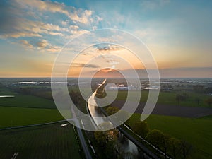 Dramatic sunset over canal Dessel Schoten aerial photo in Rijkevorsel, kempen, Belgium, showing the waterway in the