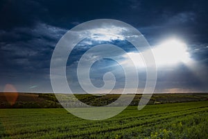 Dramatic sunset over fields with clouds