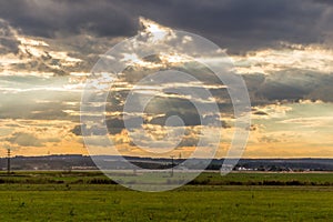 Dramatic sunset over green field