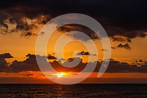 Dramatic sunset over ocean. Sky with clouds