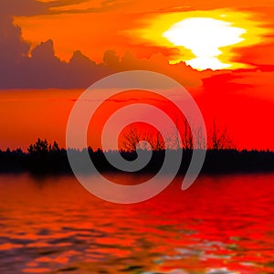 dramatic sunset reflected in a calm lake