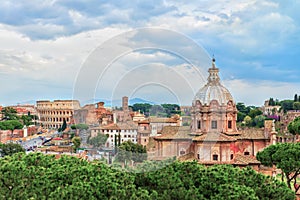 Dramatic sunset sky above the Church of Santi Luca e Martina and Great Roman Colosseum