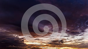 Dramatic sunset in the Sky through cumulus storm clouds,