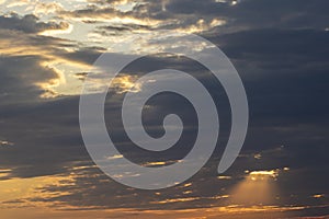 Dramatic sunset in the Sky through cumulus storm clouds,