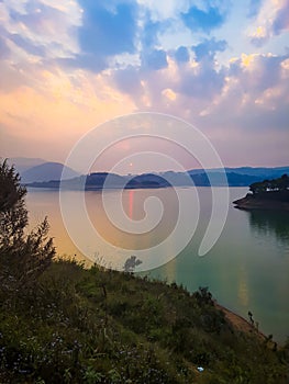 Dramatic sunset sky at evening with river reflection from flat angle