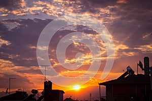 Dramatic sunset sky with orange and blue colored clouds