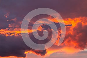 Dramatic sunset sky with orange colored clouds