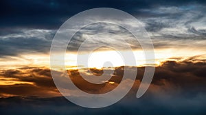 Golden Light Breaking Through Dramatic Clouds at Sunset