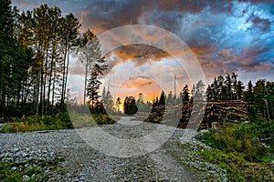 Dramatic sunset sky over a gravelroad in Varmland Sweden photo
