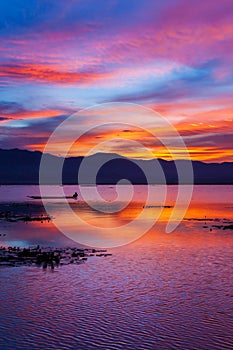 Dramatic sunset sky over the lake and mountains