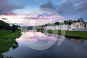 Dramatic sunset sky over the Tvertsa River and its picturesque shores after storm. Russian provincial town Torzhok, Tver region.