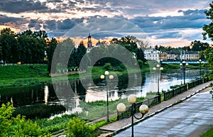 Dramatic sunset sky over the Tvertsa River and its picturesque shores after storm. Russian provincial town Torzhok, Tver region.