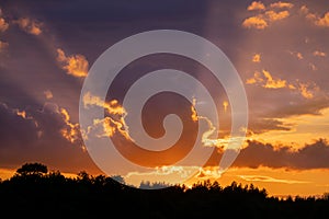 Dramatic sunset sky panorama with burning colourful clouds background. Idyllic cloudscape backdrop at dawn. Majestic cloud scenery