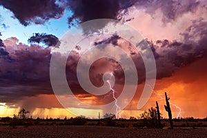 Dramatic sunset sky with storm clouds and lightning over the Arizona desert.