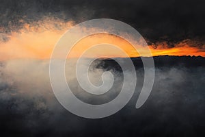 Dramatic sunset with smoky, hazy cloudscape .