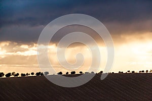 Dramatic Sunset and Stormy Overcast Sky over Rolling Hills Landscape in South of France